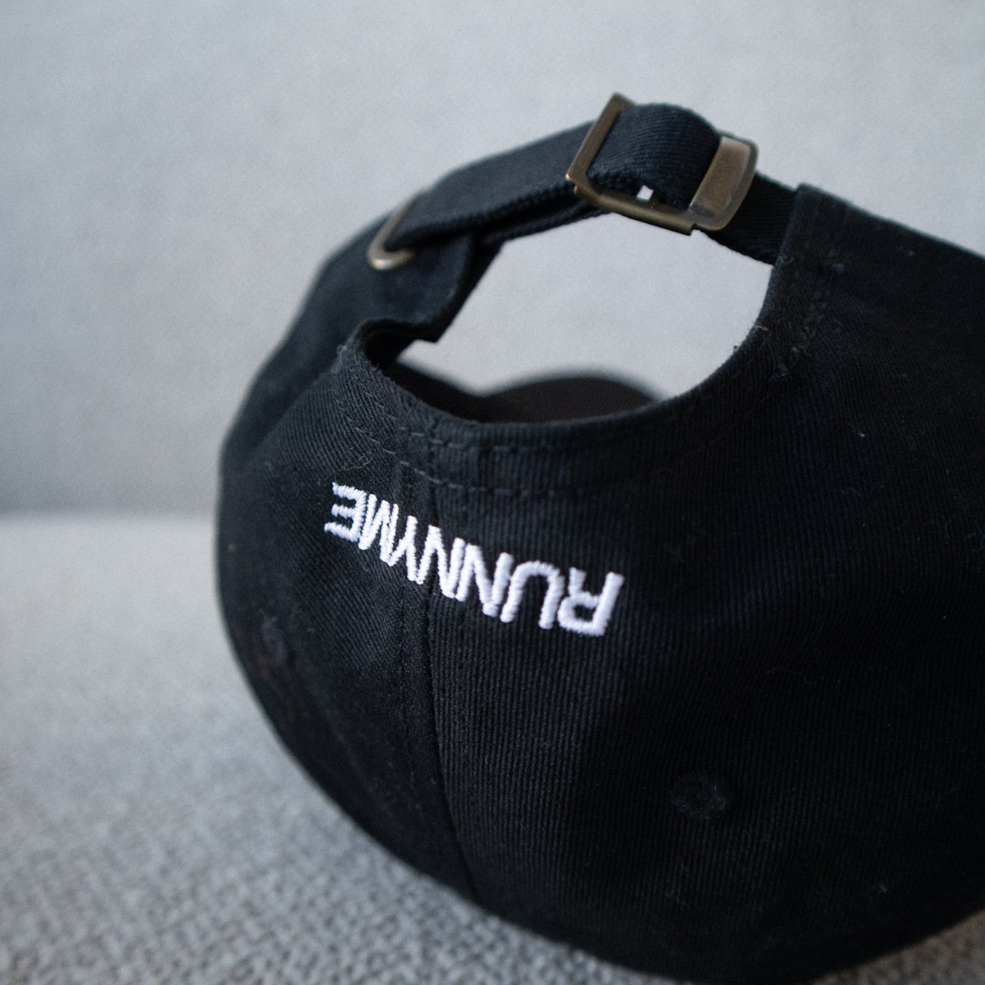 Black cap with white RUNNYME text