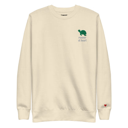 Beige sweatshirt with a green turtle graphic and text runner at heart